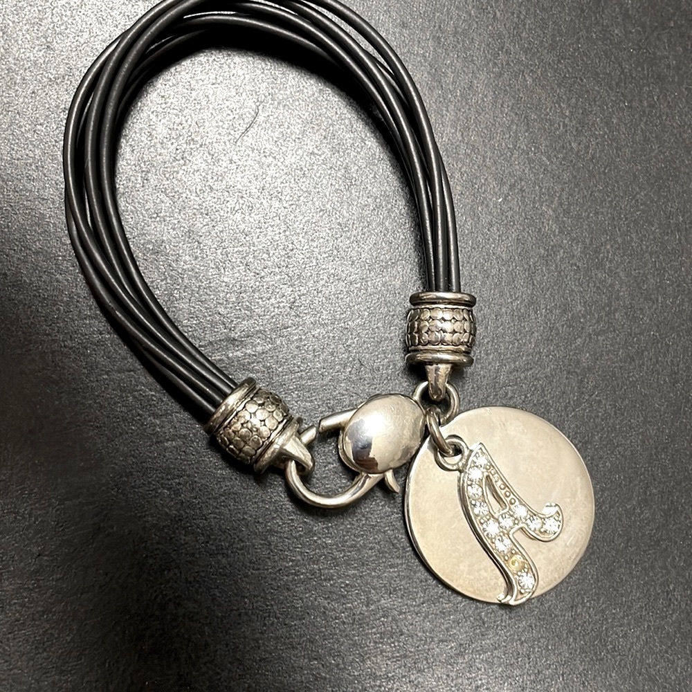 Leather cord rhinestone ‘A’ charm and silver disc bracelet.